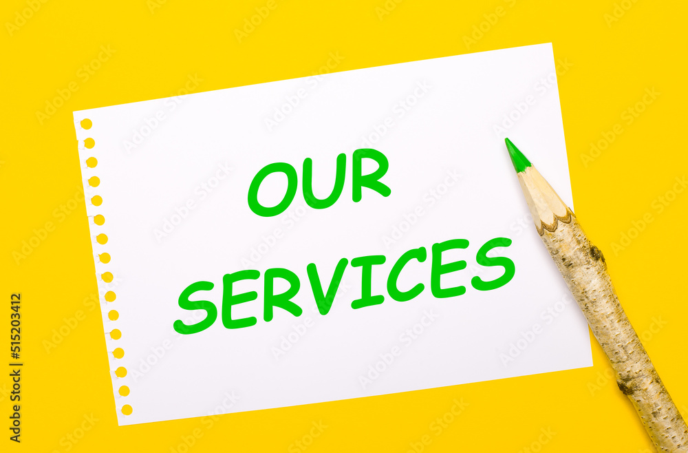 On a bright yellow background, a large wooden pencil and a white sheet of paper with the text OUR SERVICES On a bright yellow background, a large wooden pencil and a white sheet of paper with the text OUR SERVICES