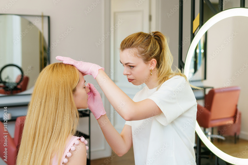 Eyebrow master while working in a beauty salon Eyebrow master while working in a beauty salon