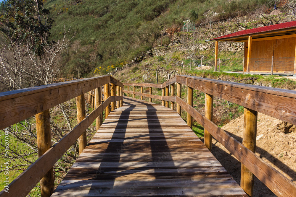 Obraz premium The river hiking trail Ecovia do Vez near Arcos de Valdevez, Portugal. Ecovia do Vez wooden pathways along the riverside.