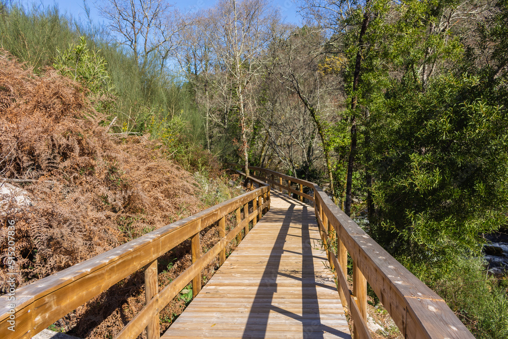 The river hiking trail Ecovia do Vez near Arcos de Valdevez, Portugal. Ecovia do Vez wooden pathways along the riverside.