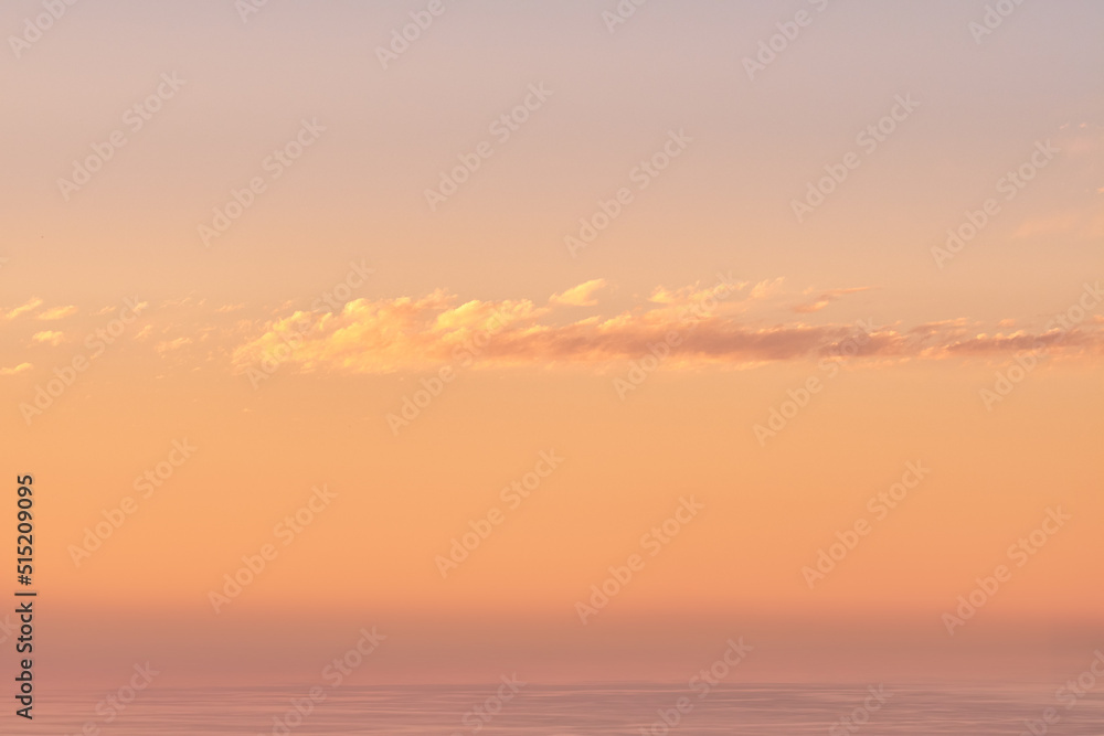 Seascape copy space with clouds in an orange sunset sky with a copyspace background. Calm, serene, tranquil, peaceful and zen ocean and sea view at dusk. Beautiful scenic mother nature in the evening