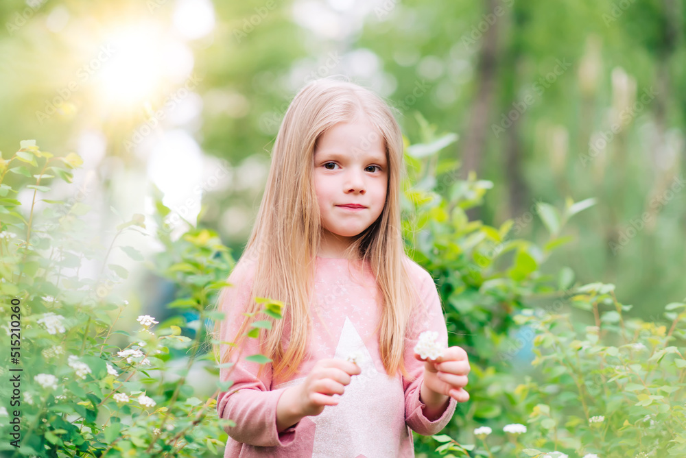 cute little girl with flowers in the park cute little girl with flowers in the park
