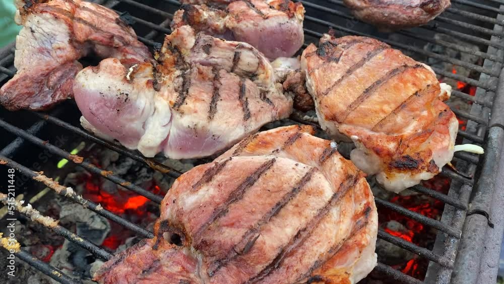 Close-up steaks are fried on a brazier grill on charcoal. Picnic in the country. Cooking barbecue and steaks. Summer holidays and vacations. Close-up steaks are fried on a brazier grill on charcoal. Picnic in the country. Cooking barbecue and steaks. Summer holidays and vacations.