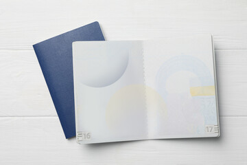 Blank passports on white wooden table, flat lay