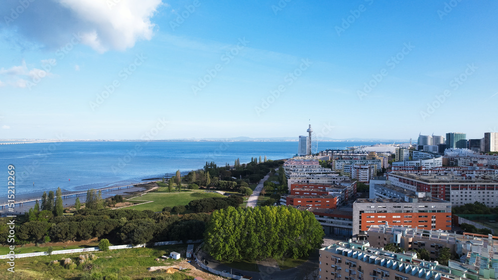 Lisbon, Portugal, April 24, 2022: DRONE AERIAL SHOT - The Vasco da Gama Tower and Myriad Hotel at Park of Nations in Lisbon. Modern residential neighborhood with contemporary architecture.