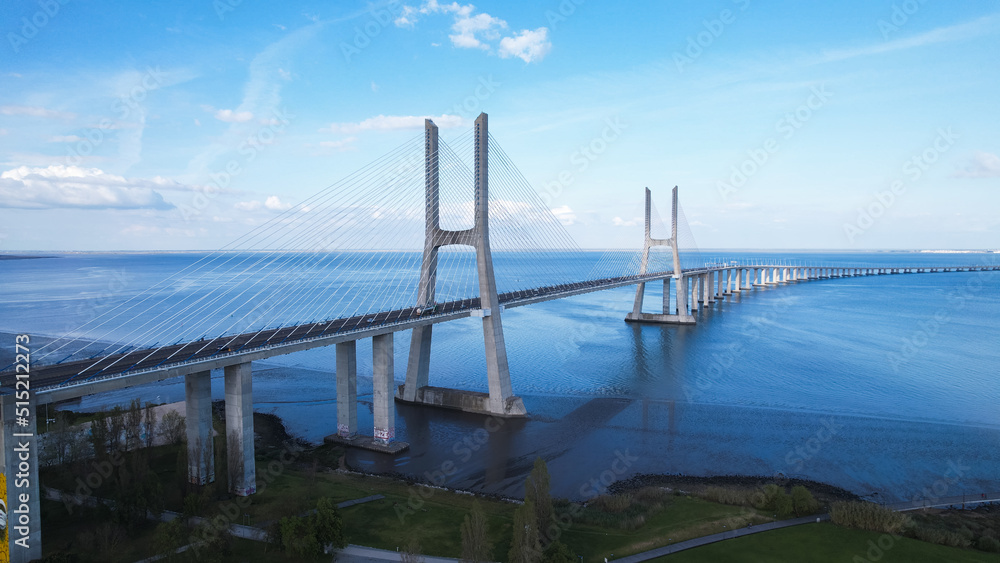 Fototapeta premium Aerial view of the Vasco da Gama Bridge is a cable-stayed bridge located in the city of Lisbon in Portugal and crosses the Tagus River. It is the second-longest bridge in Europe.
