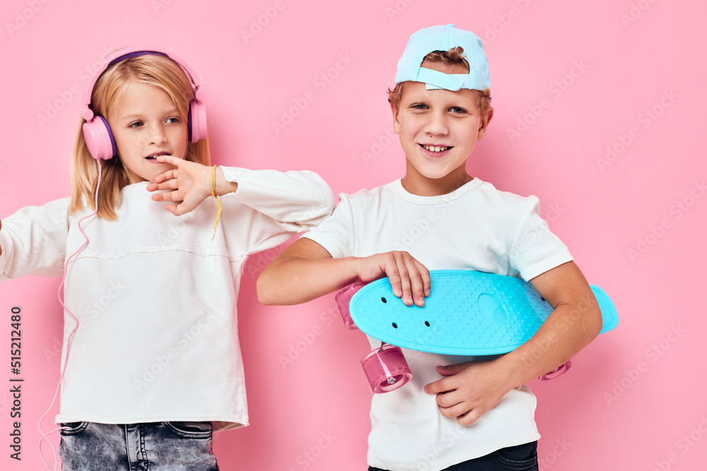 Portrait of two young smiling kids smiling and listening to music in headphones lifestyle childhood Portrait of two young smiling kids smiling and listening to music in headphones lifestyle childhood