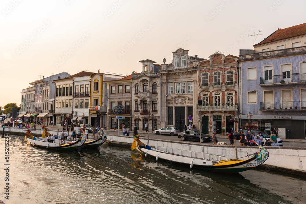 Aveiro, Portugal, August 21, 2021: View of the main city canal in Aveiro and Vouga River with traditional Moliceiro boats (gondolas) on the canal. Moliceiro transporting tourists.
