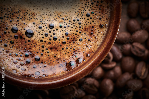 Cup of freshly brewed coffee with foam close up © amixstudio