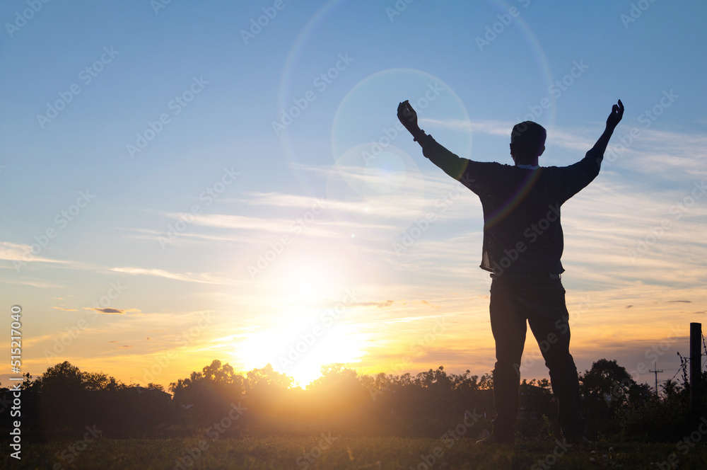 Silhouette a man standing on cliff and see sun up.freedom,happy,feel good.Photo concept active and nature background. Silhouette a man standing on cliff and see sun up.freedom,happy,feel good.Photo concept active and nature background.