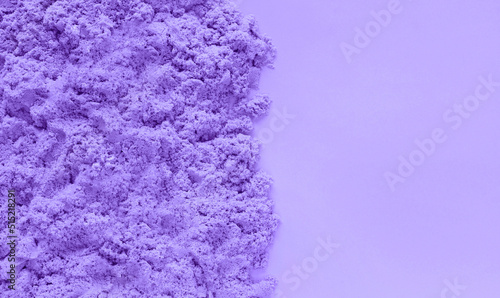 Obraz na płótnie Violet kinetic sand on very peri color paper background with copy space. Early sensory education for children. Kids development concept. Inspired by trendy Pantone color of the year 2022 Very Peri. w salonie