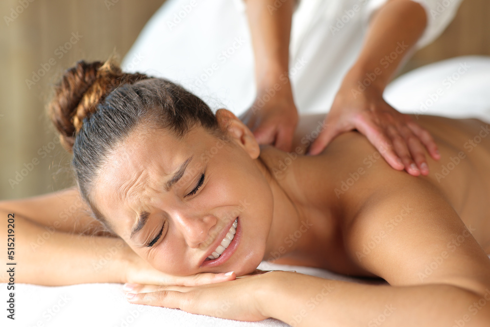 Woman complaining and physiotherapist doing massage Woman complaining and physiotherapist doing massage