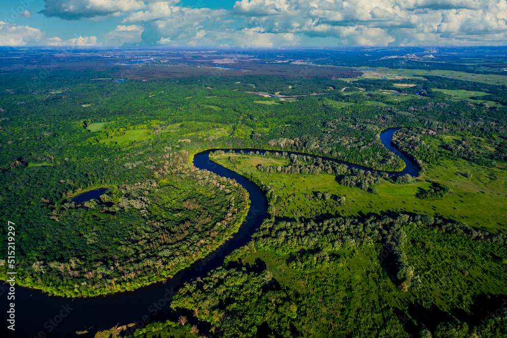 river flows through the valley in summer. Beautiful landscape cloudy sky. Aerial view. The bend of the river. Panorama. River landscape. Drone photography river flows through the valley in summer. Beautiful landscape cloudy sky. Aerial view. The bend of the river. Panorama. River landscape. Drone photography