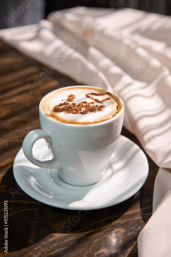 Isolated cappuccino with decorated topping in a white cup on red background copy space
