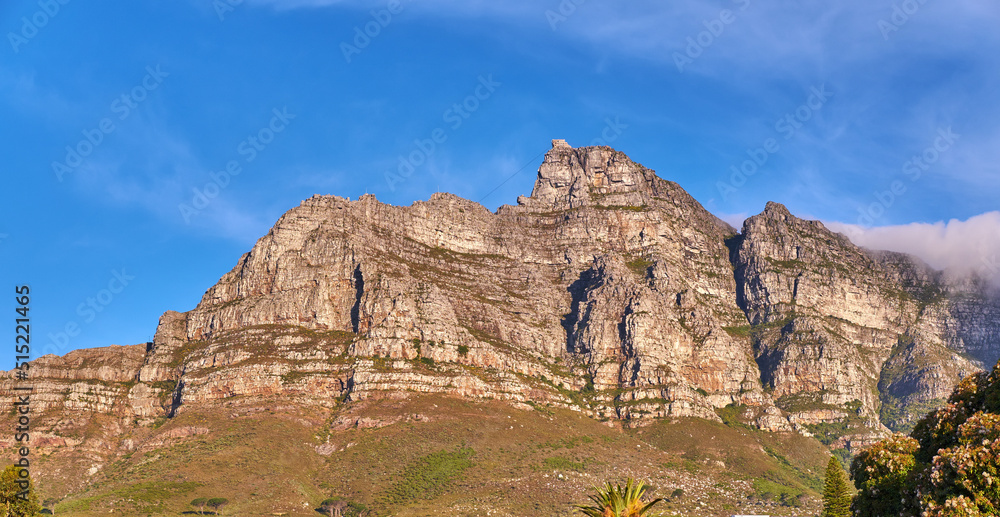 Copy space with Table Mountain in Cape Town South Africa against a blue sky background from below. Beautiful and calm landscape view of an iconic landmark and famous travel destination on a sunny day