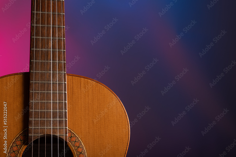 Classical guitar on a gelled color background 
