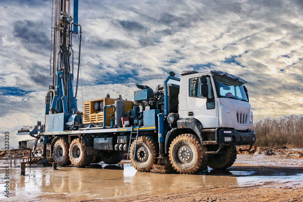 Close-up of a car-based drilling rig at a construction site. Drilling deep wells for mining.. Working process of drilling a well.