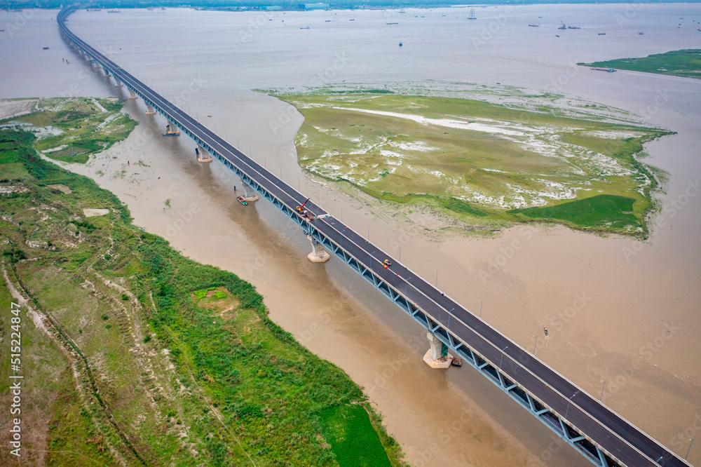 Aerial view of Padma bridge, over the padma river by day in lateral