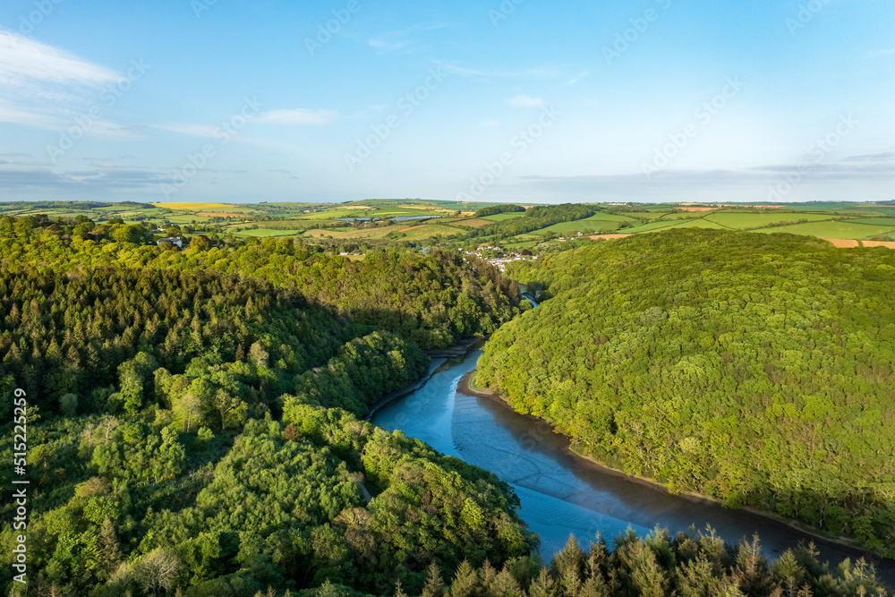 Aerial view looking down the river Lerryn above the treetops at sunset, Lostwithiel, Lerryn, Cornwall, United Kingdom. Aerial view looking down the river Lerryn above the treetops at sunset, Lostwithiel, Lerryn, Cornwall, United Kingdom.