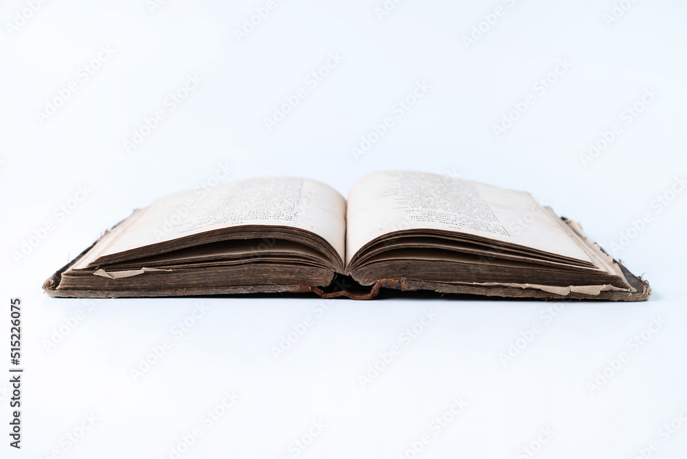 Opened old book on a white background.
