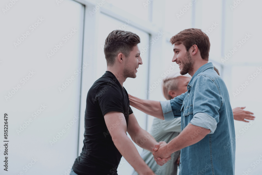 happy coworkers hugging each other when meeting happy coworkers hugging each other when meeting