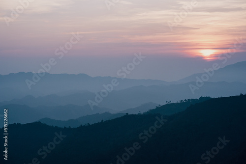 wide view  layer of mountain with sunrise background © tickcharoen04