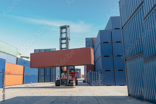 container Stacking multiple containers, and container forklifts, for import and export business.