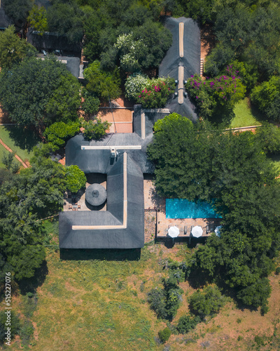 Phalaborwa, South Africa - 22 March 2022: Aerial View of luxurious accommodations with swimming pool immersed in the forest. photo