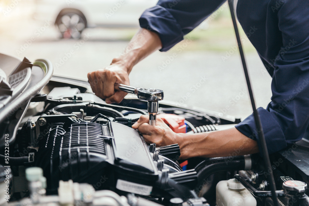 Automobile mechanic repairman hands repairing a car engine automotive workshop with a wrench, car service and maintenance,Repair service. Automobile mechanic repairman hands repairing a car engine automotive workshop with a wrench, car service and maintenance,Repair service.