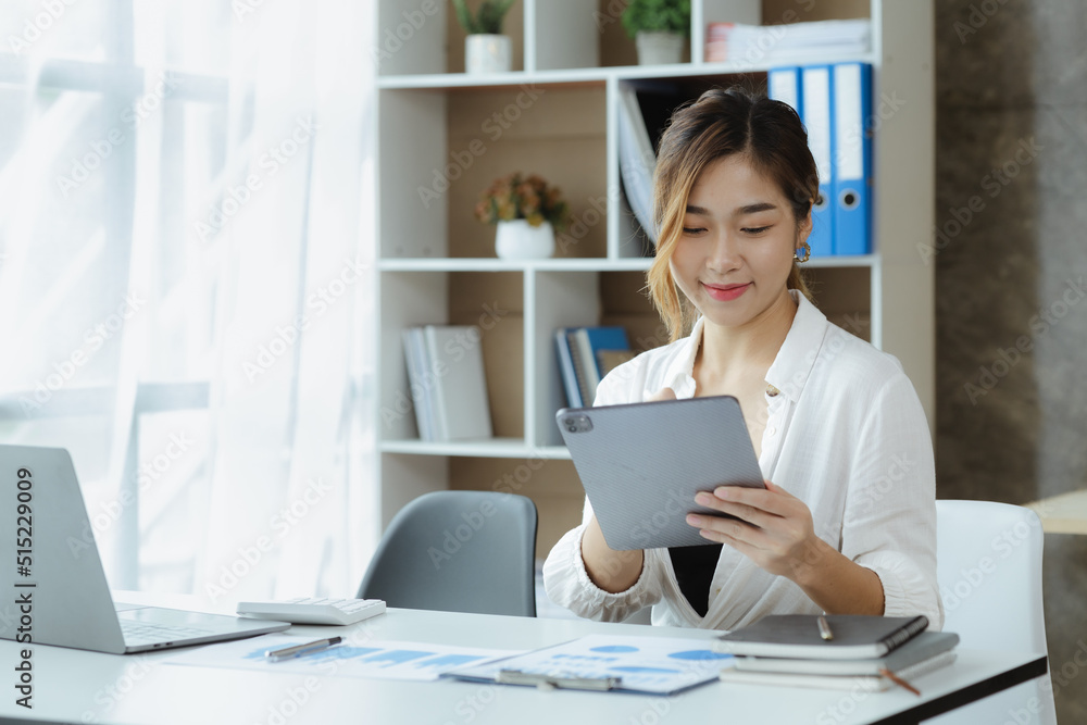Woman sitting using tablet, Asian businesswoman using tablet to communicate with business partner with messenger. Concept of using technology in communication, business administration by women.