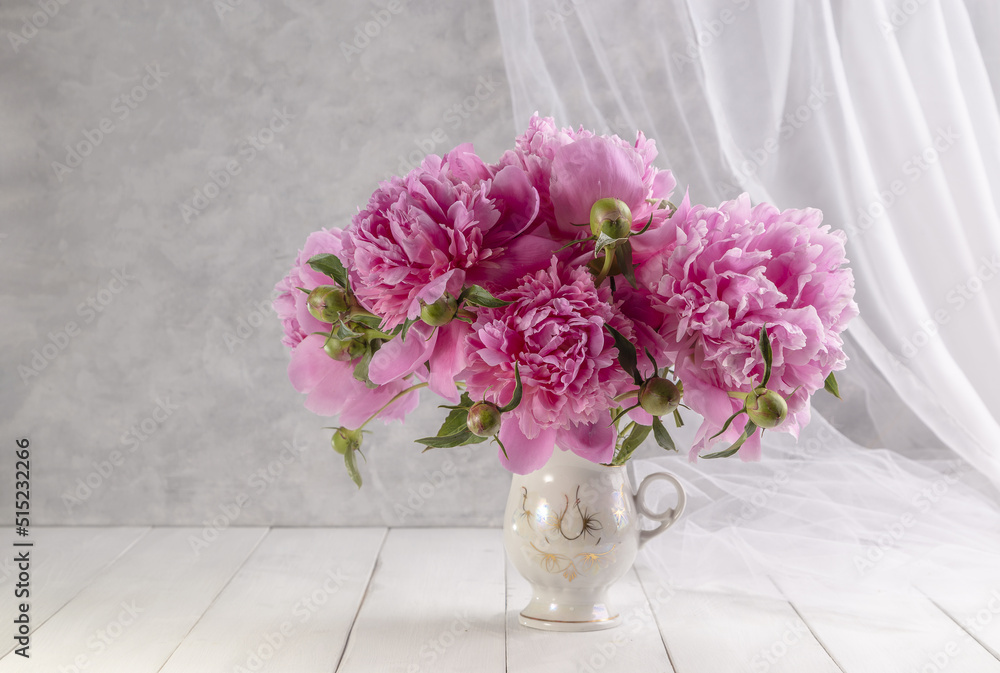 Bouquet of pink peonies in a vase on a wooden table. Gift Valentine's Day Bouquet of pink peonies in a vase on a wooden table. Gift Valentine's Day