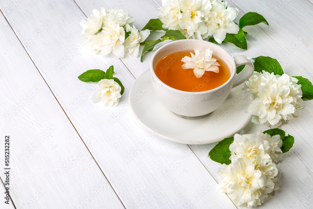 Jasmine tea in a cup on a wooden background. Copy space Jasmine tea in a cup on a wooden background. Copy space