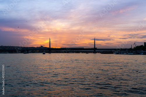 Sunset over the city of Istanbul, with a mosque in the photo, with the blue and orange sky, sailing on the Bosphorus