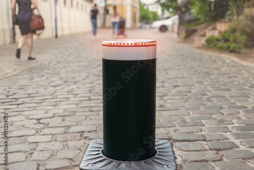 Wallpaper Mural Close-up automatic metal rising smart security bollard barrier for safety car traffic in old city center pedestrian area. Walkway street electric remote access control system on pavement road Torontodigital.ca