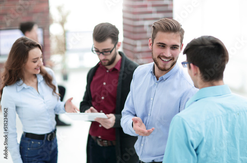 Manager consulting with his colleagues in the office.