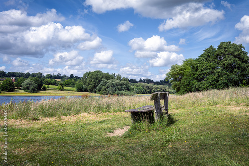 Wooden bench on the shore of Bewl Water, Kent, England photo