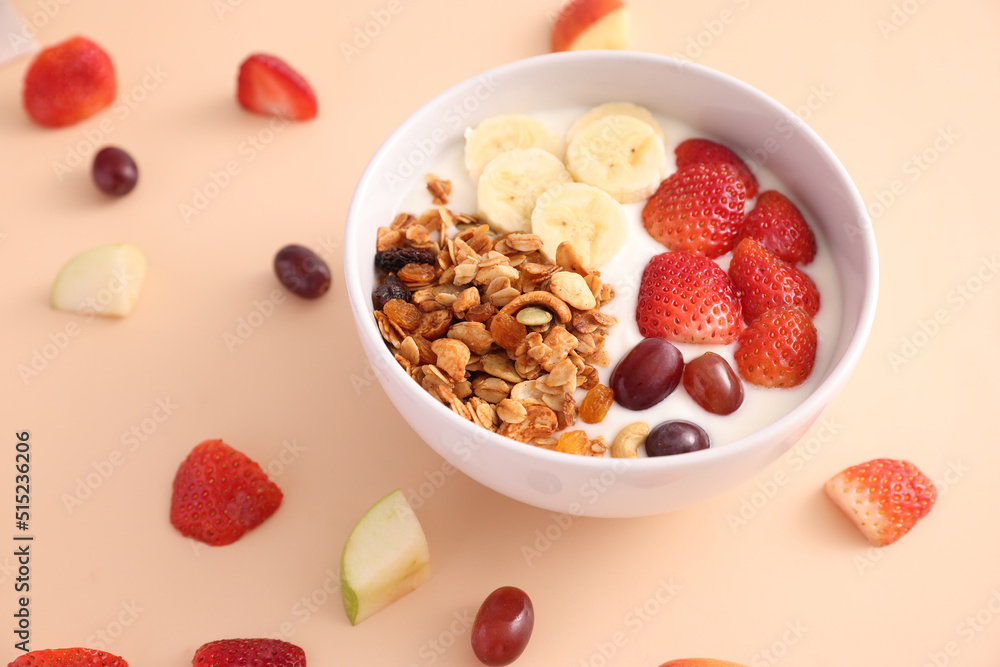 bowl of granola cereal with yogurt and berries isolated on eggnog color background bowl of granola cereal with yogurt and berries isolated on eggnog color background