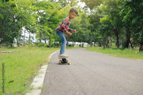 Asian boy having fun skateboarding in the park © boonchok