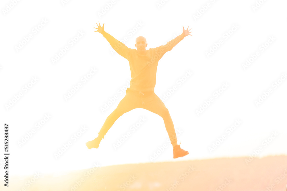 Young athletic man jumping high during sunset Young athletic man jumping high during sunset