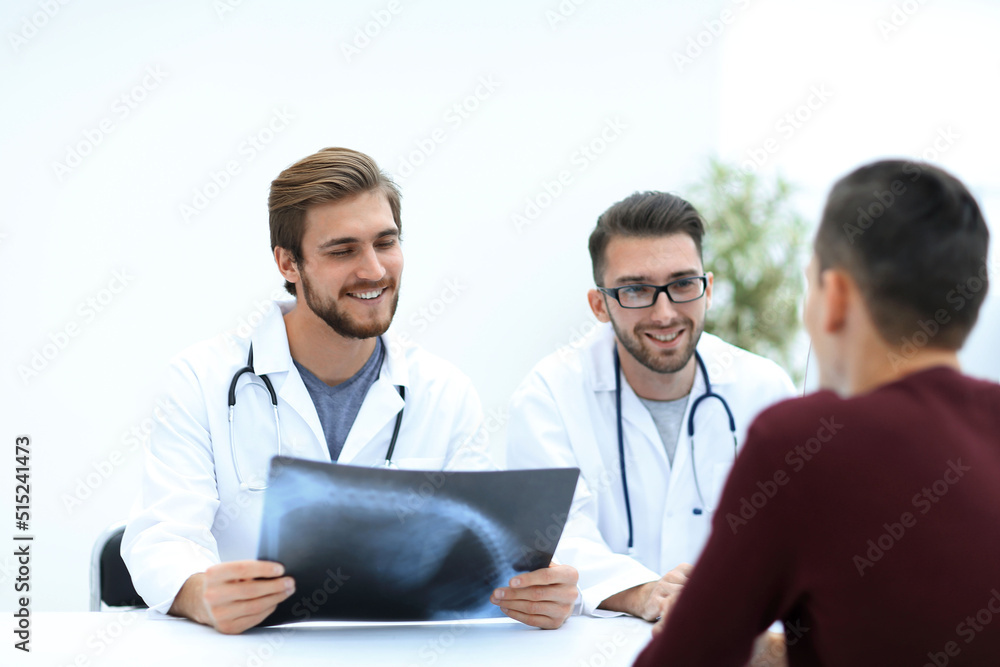 group of doctors welcoming their customer with a handshake group of doctors welcoming their customer with a handshake
