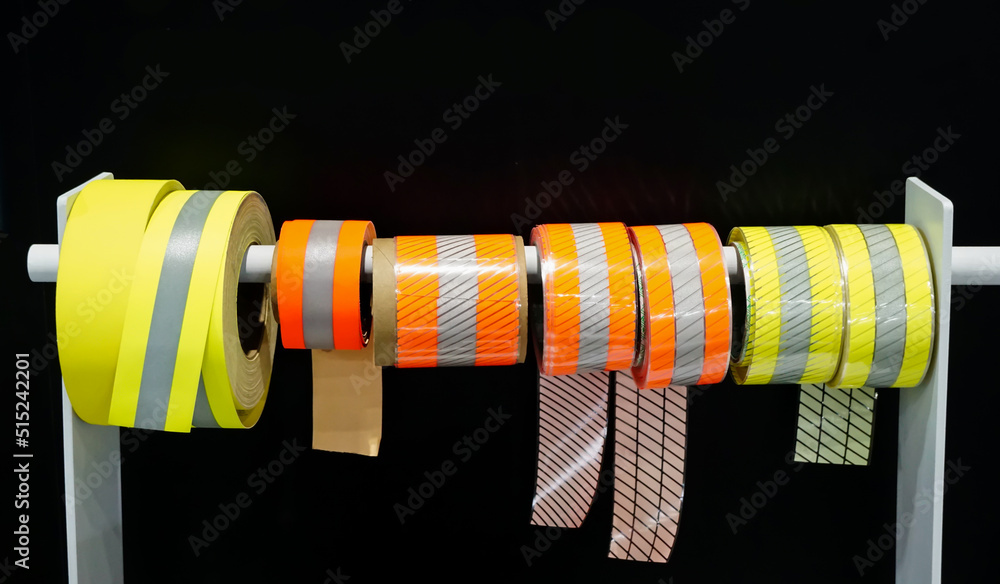 Obraz premium Reflective Adhesive Sticker for Safety in Rolls on a black background.