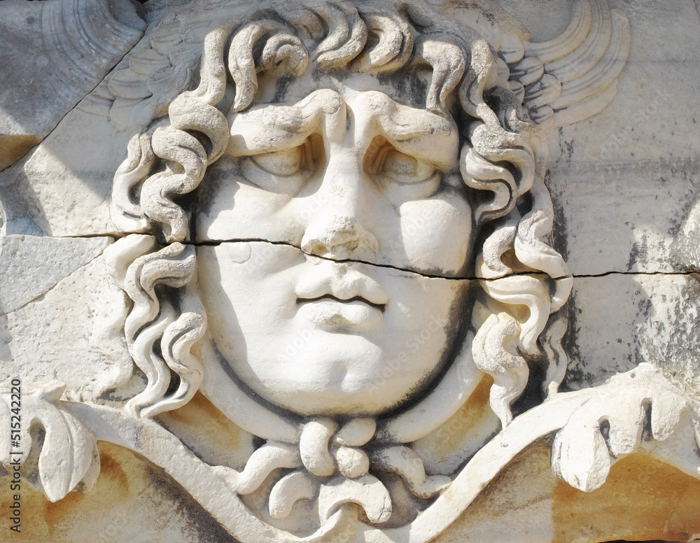 Closeup of a face carved on marble in classical style by ancient Greeks at the Temple of Apollo in Didyma. An impressive ruined sanctuary or statue in Hellenic city of Miletus, in southwest Turkey