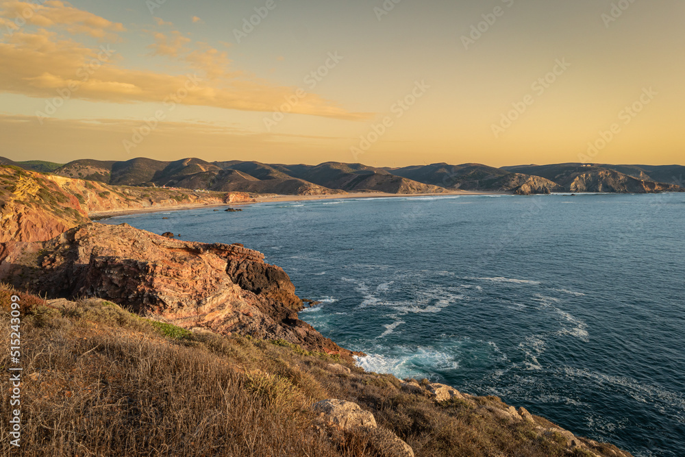 Sunset view to beach with rocks in Praia do Amado in Algarve Portugal