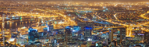 Wide angle of a city at night from above. Futuristic panorama of the lights of Cape Town at sunset. .A modern urban landscape of an illuminated city. High angle view from Signal Hill in South Africa