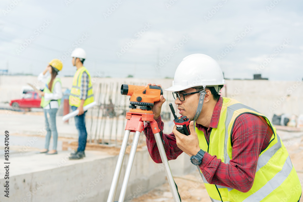 Engineer holding walkie talkie working at construction site. Engineer holding walkie talkie working at construction site.