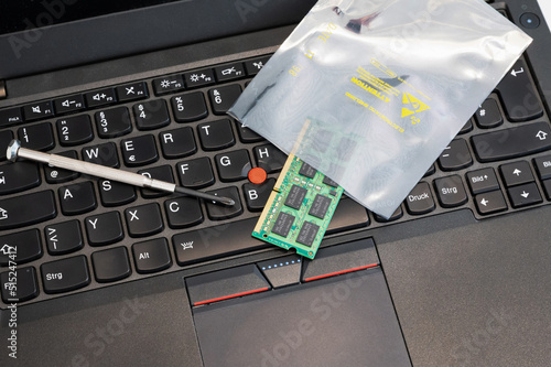 RAM is upgraded and placed in ESD packaging on a PC keyboard. The packaging protects sensitive electronic components from electrostatic discharge. photo
