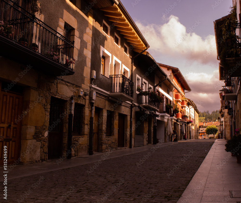 Fototapeta premium rural village street with antique houses in northern spain with cloudy skies. romantic weekend getaway