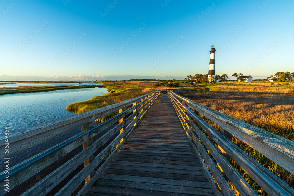 Lighthouse and Boardwalk through a Marsh at Bodie Island near Nags Head, NC.