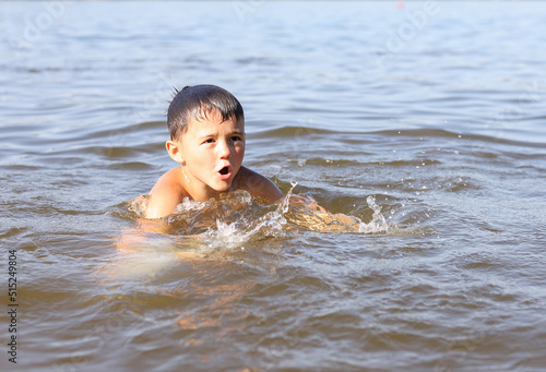 a boy swims in the water