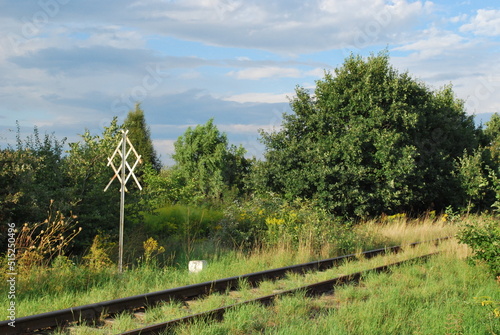 railroad track, scrub and railroad sign photo